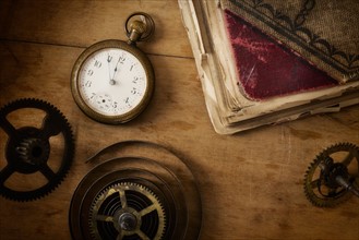 Still life with pocket watch and gears.
