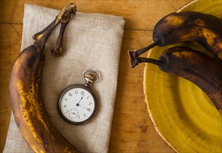 Still life with bananas and pocket watch.