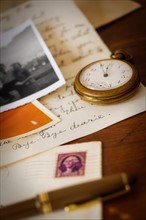 Still life with pocket watch, old letter and photograph.