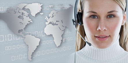 Woman with headset with world map in background.