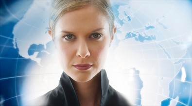 Portrait of businesswoman with world map in background.
