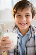 Boy (8-9) drinking milk