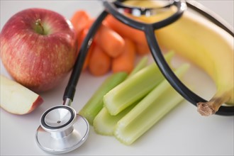 Studio shot of stethoscope with fruits and vegetables