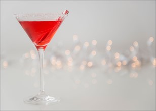 Studio shot of red cocktail in martini glass