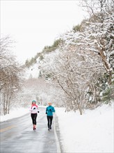 Two women jogging in winter