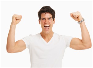 Studio portrait of handsome man cheering and flexing muscles
