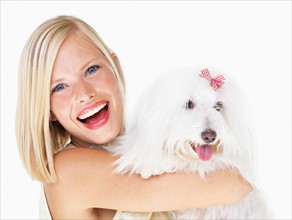 Studio Shot, Portrait of young woman holding dog
