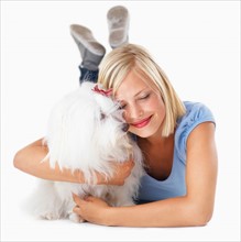 Studio Shot, Portrait of young woman hugging her dog
