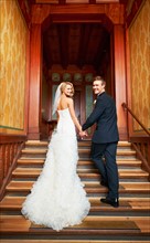 Young couple standing on steps in hallway