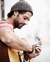 Portrait of musician playing guitar outdoors