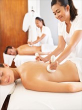 Two people getting massage in spa