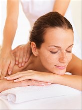 Woman relaxing while getting massage