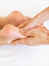 Hand massaging feet