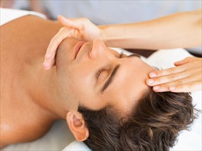 Man receiving massage in spa