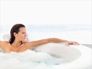 Woman relaxing in bathtub