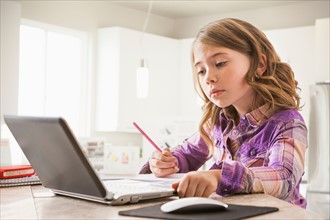 Girl (6-7) using laptop
