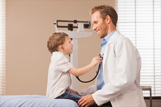 Boy (2-3)  listening heartbeat of pediatrician