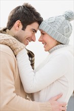 Profile of couple in winter clothing.