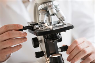 Close-up of scientist doing research on microscopes.