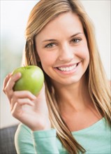 Portrait of woman holding apple.