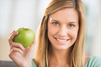 Portrait of woman holding apple.