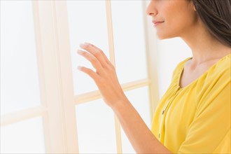 Woman looking through window.