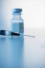 Close up of syringe and medication, studio shot.