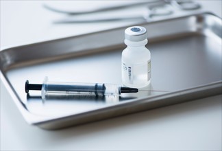 Close up of syringe and medication, studio shot.