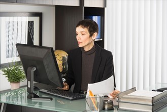 Businesswoman working at desk.