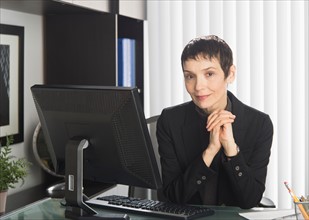 Portrait of businesswoman at desk.