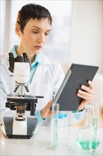 Woman using digital tablet in laboratory.
