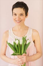 Portrait of mature woman with tulips.