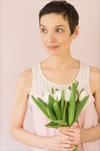 Portrait of mature woman with tulips.