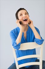 Woman laughing when using mobile phone.