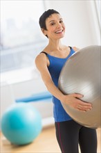 Portrait of mature woman exercising in gym.