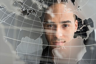 Digital portrait of young man on world map.