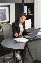 Businesswoman working at desk in office.