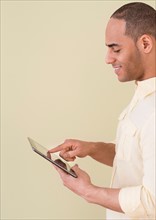 Young man using digital tablet.
