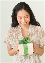 Young woman holding present.