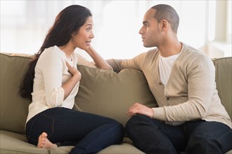 Young couple sitting on couch.