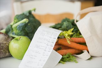 Fresh vegetables with store bill