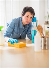 Portrait of mature woman cleaning kitchen