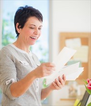Mature woman reading letters