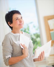 Mature woman holding letters