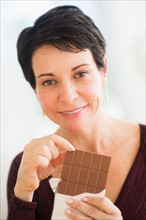 Portrait of mature woman eating chocolate