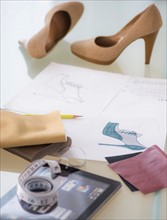 Studio Shot of digital tablet, tape measure, sketch and shoes