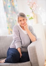 Portrait of woman relaxing on sofa