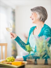 Portrait of woman raising wine glass