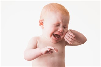 Studio shot portrait of baby boy (18-23 months) crying