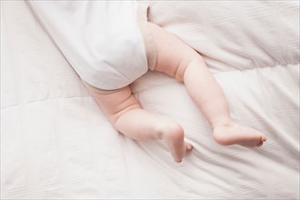 Low section of baby boy (18-23 months) lying on front